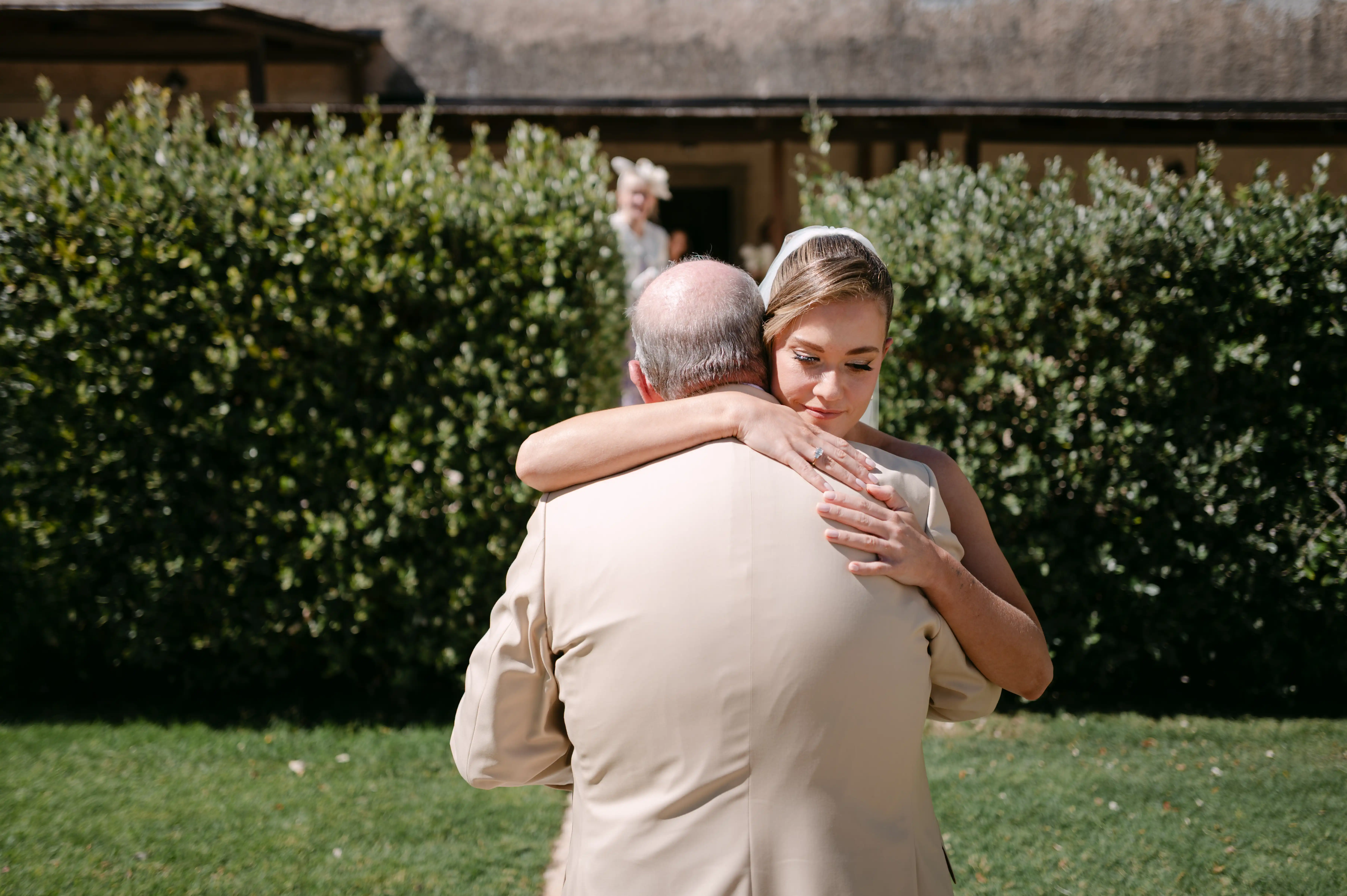 Bride hugging her father during emotional wedding morning moment in Italy